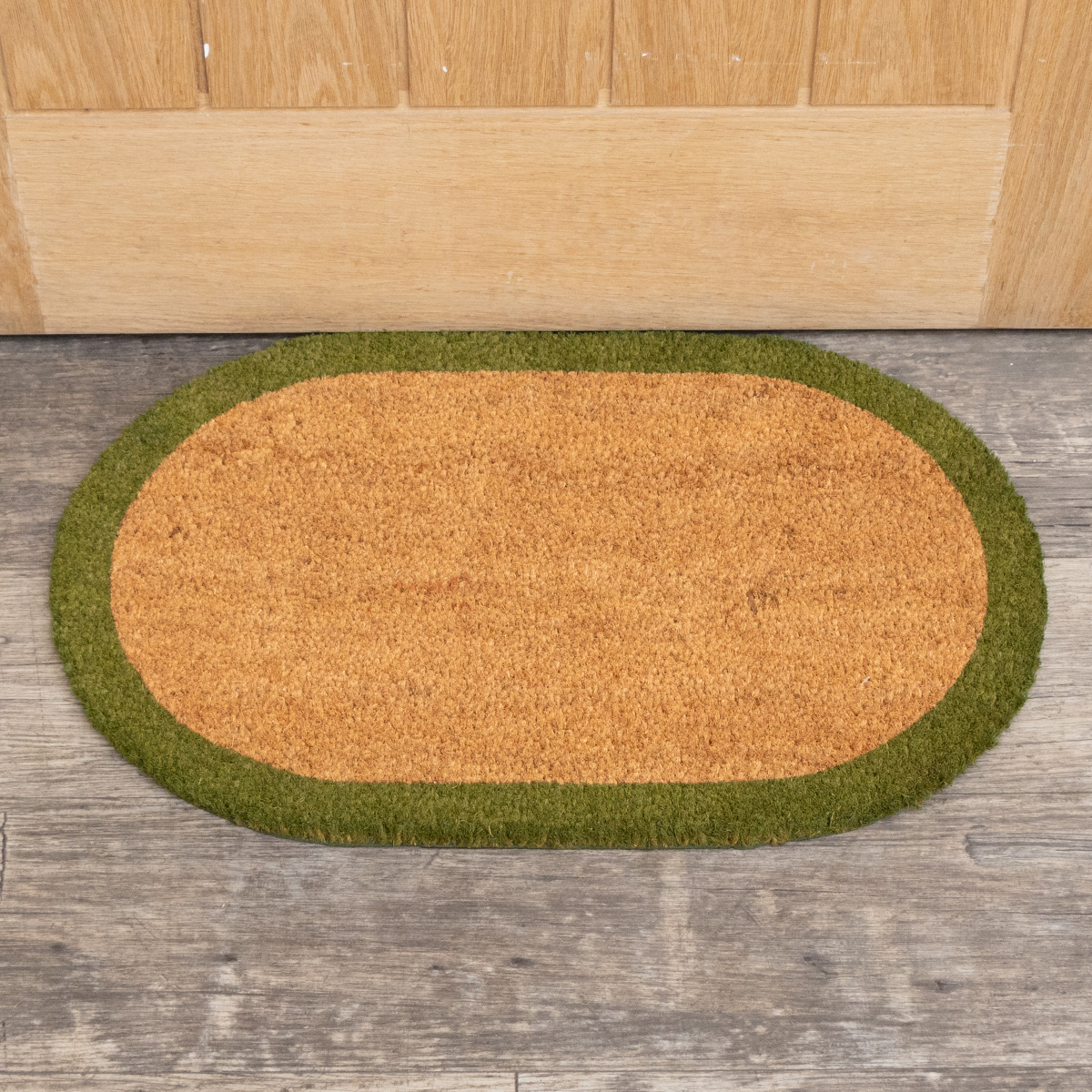 Natural Oval Coir Door Mat with a Green Border